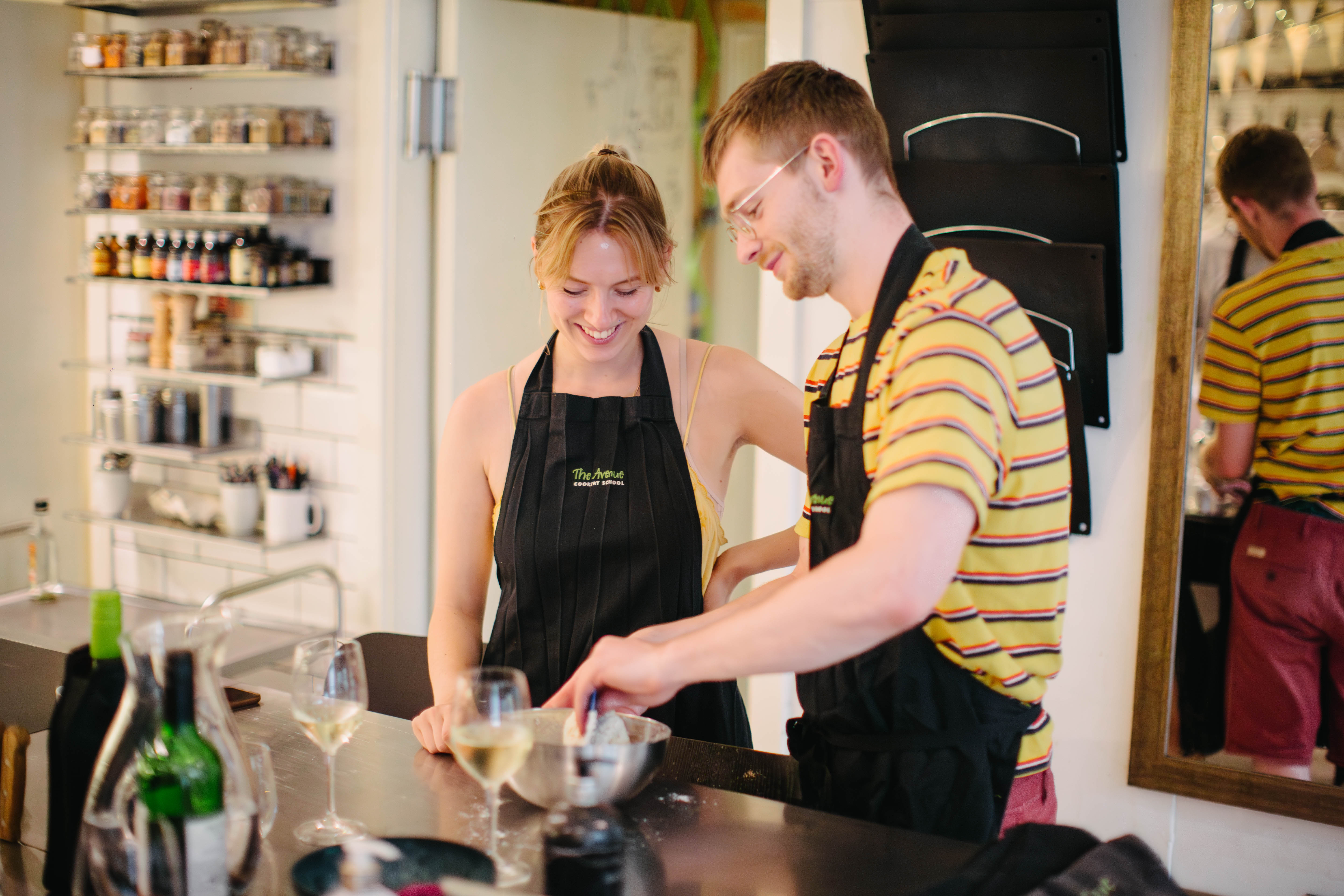 Smiling couple cooking together in an industrial kitchen